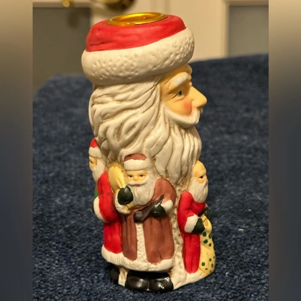 Set of 2 Santa candleholders. Each has smaller different smaller Santas.